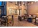 Evening view of a relaxing patio with a dining area and fire pit at 17763 N 93Rd Way, Scottsdale, AZ 85255