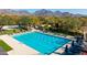 An aerial view of a sparkling pool surrounded by mature landscaping and trees at 17763 N 93Rd Way, Scottsdale, AZ 85255