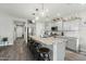 Spacious kitchen with an oversized island, pendant lighting, and modern stainless steel appliances at 17911 W Hiddenview Dr, Goodyear, AZ 85338