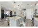 Bright kitchen island with a sink, dishwasher, and storage; open to the dining area and living room at 17911 W Hiddenview Dr, Goodyear, AZ 85338