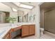 Bathroom with double vanity, large mirror, and shower stall at 19511 N 143Rd Dr, Sun City West, AZ 85375