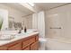 Bathroom with tub, single vanity, and shower curtain at 19511 N 143Rd Dr, Sun City West, AZ 85375