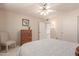 Bedroom with dresser, chair, and ceiling fan at 19511 N 143Rd Dr, Sun City West, AZ 85375