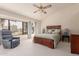 Spacious bedroom with large windows and ceiling fan at 19511 N 143Rd Dr, Sun City West, AZ 85375
