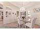Charming dining room with glass table and chandelier at 19511 N 143Rd Dr, Sun City West, AZ 85375