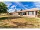 Rear view of the house showcasing a large grassy yard at 19511 N 143Rd Dr, Sun City West, AZ 85375