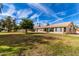 House exterior with a large yard and mature trees at 19511 N 143Rd Dr, Sun City West, AZ 85375