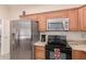 Kitchen boasts stainless steel appliances and ample counter space at 19511 N 143Rd Dr, Sun City West, AZ 85375