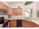 Modern kitchen with stainless steel appliances and wood cabinets at 19511 N 143Rd Dr, Sun City West, AZ 85375
