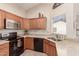 Modern kitchen with stainless steel appliances and wood cabinets at 19511 N 143Rd Dr, Sun City West, AZ 85375