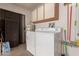 Laundry room with washer, dryer, and storage cabinets at 19511 N 143Rd Dr, Sun City West, AZ 85375