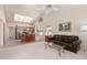 Bright living room with vaulted ceilings, kitchen island, and a view into the kitchen at 19511 N 143Rd Dr, Sun City West, AZ 85375
