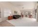 Living room with a black leather couch and two armchairs at 19511 N 143Rd Dr, Sun City West, AZ 85375