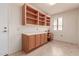 Home office with built-in desk and shelving at 19511 N 143Rd Dr, Sun City West, AZ 85375