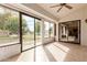 Sunroom with sliding glass doors and view of backyard at 19511 N 143Rd Dr, Sun City West, AZ 85375