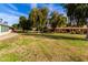 Large backyard with mature trees and grassy areas at 19511 N 143Rd Dr, Sun City West, AZ 85375
