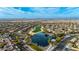 Aerial view of a community with houses, golf course, and lake at 26686 W Piute Ave, Buckeye, AZ 85396