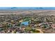 Aerial view of a community with houses, golf course, and lake at 26686 W Piute Ave, Buckeye, AZ 85396