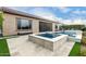 Inviting backyard with a sparkling pool, spa, and patio area at 26686 W Piute Ave, Buckeye, AZ 85396