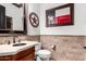 Modern bathroom with tiled walls, vanity, and Texas-themed decor at 26686 W Piute Ave, Buckeye, AZ 85396