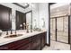 Double vanity bathroom with a large walk-in shower at 26686 W Piute Ave, Buckeye, AZ 85396