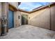 Bright courtyard with tile flooring, a blue door, and decorative sculptures at 26686 W Piute Ave, Buckeye, AZ 85396