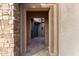 Private courtyard entry with stone and stucco details, blue door, and stone tile flooring at 26686 W Piute Ave, Buckeye, AZ 85396