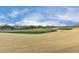 View of a lush green golf course with homes in the background at 26686 W Piute Ave, Buckeye, AZ 85396
