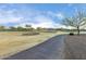 Golf course with paved pathway and mature trees at 26686 W Piute Ave, Buckeye, AZ 85396