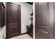 Subdued hallway with dark brown doors and built-in shelving at 26686 W Piute Ave, Buckeye, AZ 85396