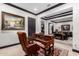 Elegant home office features a large desk, leather chair, and view into the living area at 26686 W Piute Ave, Buckeye, AZ 85396