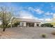 Back of house with covered patio, and desert landscaping at 26686 W Piute Ave, Buckeye, AZ 85396