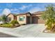 Two-car garage and front entrance with stone accents at 26686 W Piute Ave, Buckeye, AZ 85396