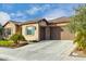Two-car garage and front entrance with stone accents at 26686 W Piute Ave, Buckeye, AZ 85396