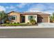 Two-car garage and front entrance with stone accents at 26686 W Piute Ave, Buckeye, AZ 85396