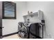 Clean laundry room with washer, dryer, and overhead shelving at 26686 W Piute Ave, Buckeye, AZ 85396