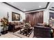Cozy living room with a brown sofa and matching chairs at 26686 W Piute Ave, Buckeye, AZ 85396