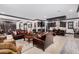 Open concept living area with dark wood cabinetry and leather sofas at 26686 W Piute Ave, Buckeye, AZ 85396