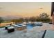 Inviting pool and spa with fire pit and golf course view at 26686 W Piute Ave, Buckeye, AZ 85396