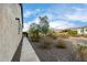 Sidewalk along house with landscaping and desert plants at 26686 W Piute Ave, Buckeye, AZ 85396