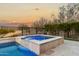 Relaxing spa with waterfall feature and tranquil sunset views at 26686 W Piute Ave, Buckeye, AZ 85396