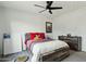 Cozy bedroom with modern ceiling fan, dresser, and framed picture creating a comfortable atmosphere at 2809 N 82Nd Pl, Mesa, AZ 85207