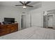 King-size bed in bright bedroom with ceiling fan and dresser at 2955 N Oregon St # 9, Chandler, AZ 85225