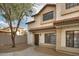 Two-story stucco townhouse with a Spanish-style tile roof and a private walkway at 2955 N Oregon St # 9, Chandler, AZ 85225