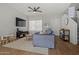 Spacious living room with L-shaped sectional sofa, TV, and hardwood floors at 2955 N Oregon St # 9, Chandler, AZ 85225