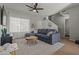 Bright living room with sectional sofa, wood floors, and a ceiling fan at 2955 N Oregon St # 9, Chandler, AZ 85225