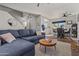 Open living and dining area with L-shaped sectional sofa and hardwood floors at 2955 N Oregon St # 9, Chandler, AZ 85225