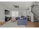 Spacious living room with L-shaped sectional sofa, TV, and hardwood floors at 2955 N Oregon St # 9, Chandler, AZ 85225