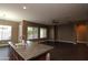 Kitchen with island, dark wood cabinets, and view to living room at 3337 W Galvin St, Phoenix, AZ 85086