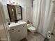 Bathroom featuring a sink, toilet, vanity lighting and shower curtain at 3341 W Windrose Dr, Phoenix, AZ 85029